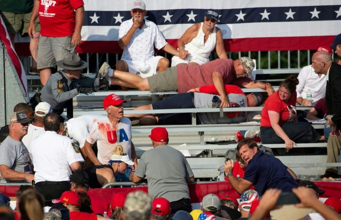 Trump supporters are seen covered with blood in the stands after guns were fired at Republican candidate Donald Trump at a campaign event at Butler Farm Show Inc. in Butler, Pennsylvania, July 13, 2024. Rebecca Droke/AFP via Getty Images