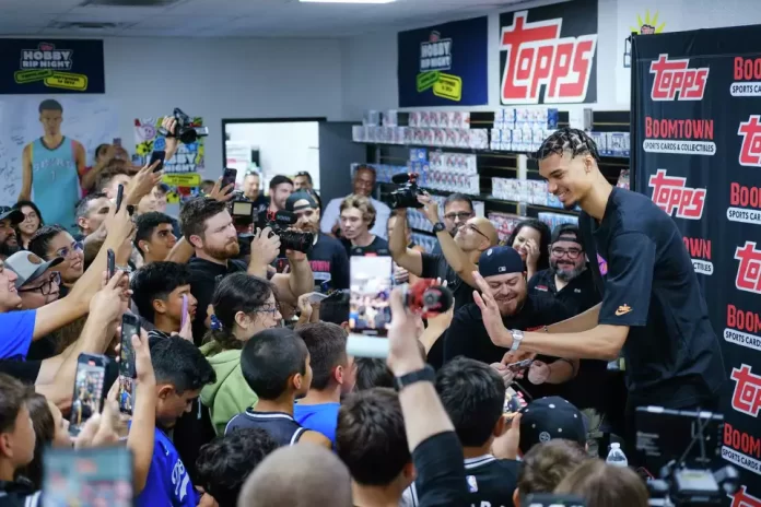 San Antonio Spurs star Victor Wembanyama opens trading cards with young fans at Boomtown Sports Cards and Collectibles on Saturday. Clint Datchuk