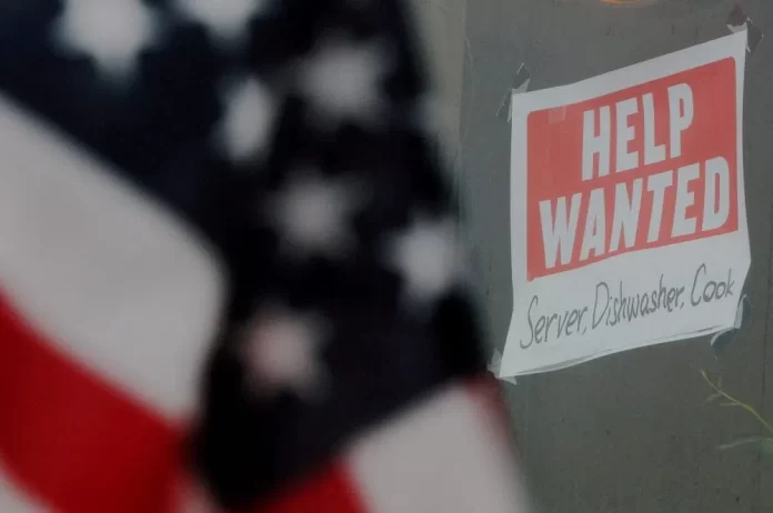 A 'Help Wanted' sign hangs in restaurant window. REUTERS/Brian Snyder/File Photo