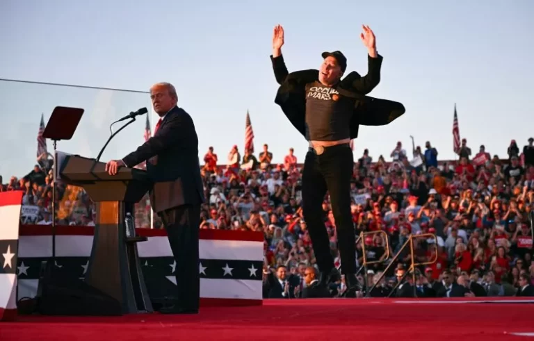 Tesla CEO Elon Musk (right) jumps onstage as he joins Donald Trump during a rally in Butler, Pennsylvania on October 5, 2024. Social media users have mocked Musk for his appearance at the Republican nominee's rally. JIM WATSON/AFP/Getty Images