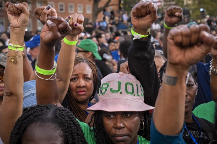 Supporters of Vice President Kamala Harris hold their fists in the air in unison after she delivered a concession speech on Nov. 6 at Howard University in Washington. (AP Photo/Jacquelyn Martin)