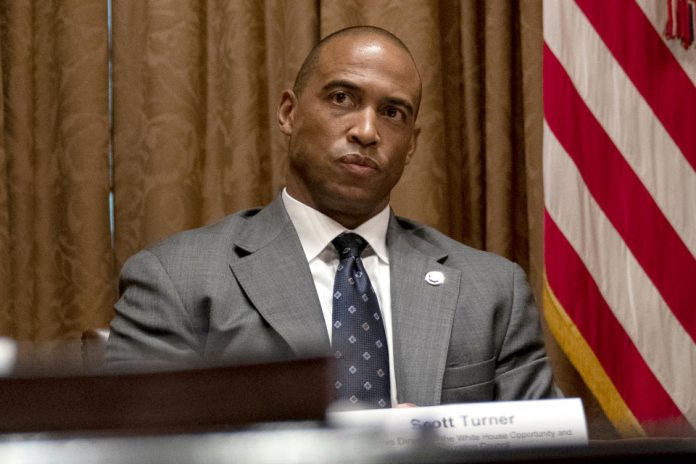 Scott Turner, the executive director of the White House Opportunity and Revitalization Council, attends a meeting in the Cabinet Room of the White House, May 18, 2020, in Washington. (AP Photo/Evan Vucci, File)