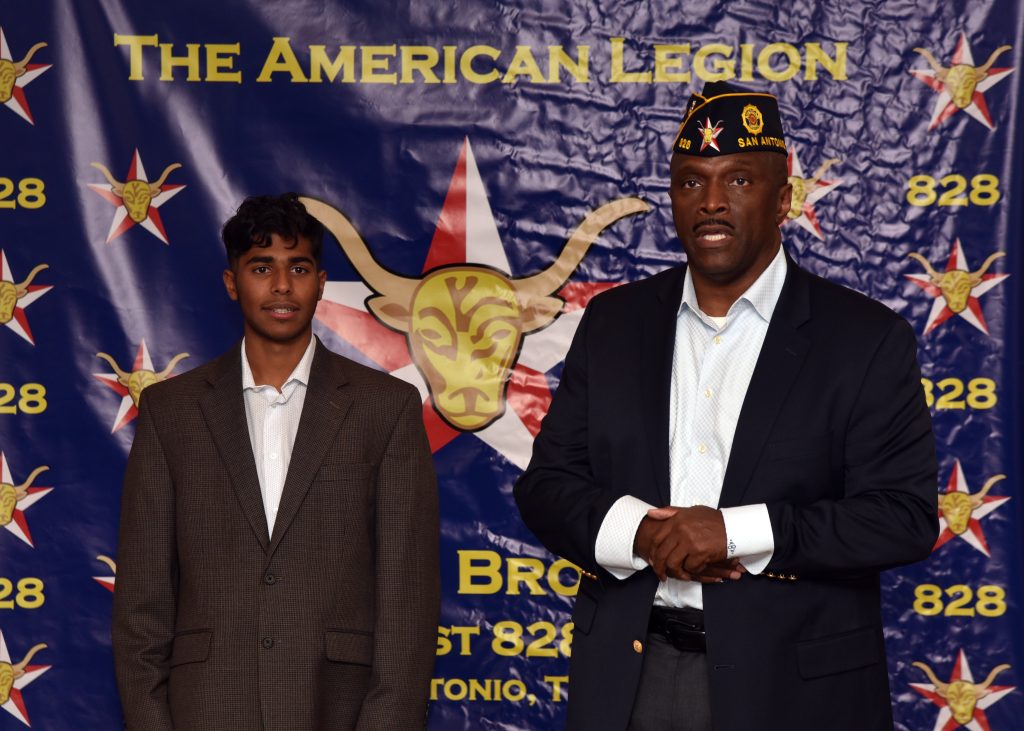 Past Department Vice Commander Billy Hill, who serves as the chairman of the Post Oratorical Contest Committee, announces Health Careers High School Junior Joshua Philip, as the first place winner of an oratorical contest. Photo: Post Commander Burrell Parmer/828