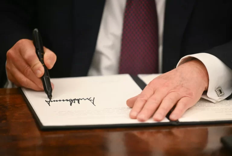 President Trump signs executive orders in the Oval Office of the White House in Washington, D.C., on Monday. Jim Watson/AFP via Getty Images