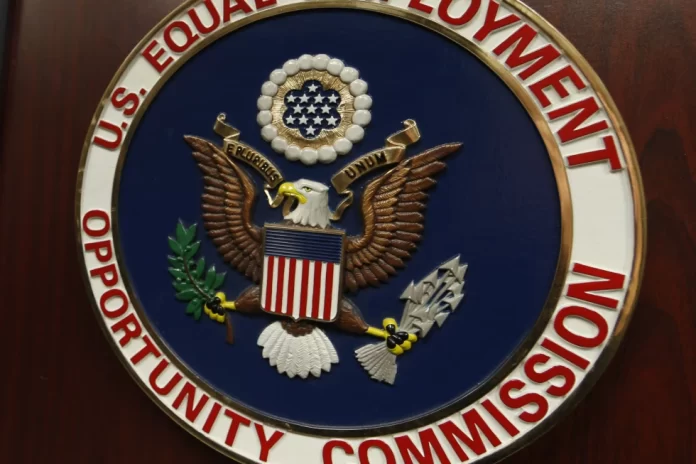 The emblem of the U.S. Equal Employment Opportunity Commission (EEOC) is shown on a podium in Vail, Colorado, Feb. 16, 2016, in Denver. (AP Photo/David Zalubowski, File)