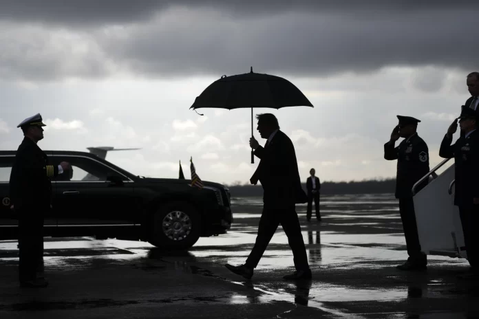 President Donald Trump, center, walks from Air Force Force One after landing at the Naval Air Station Joint Reserve Base in New Orleans, Sunday, Feb. 9, 2025, ahead of the NFL Super Bowl 59 football game between the Philadelphia Eagles and the Kansas City Chiefs. (AP Photo/Ben Curtis)