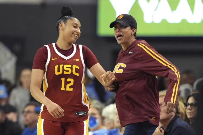 California guard JuJu Watkins, left, reacts to getting a slap on the behind from former USC player Cheryl Miller after scoring during the second half of an NCAA college basketball game against UCLA Saturday, March 1, 2025, in Los Angeles. (AP Photo/Mark J. Terrill)