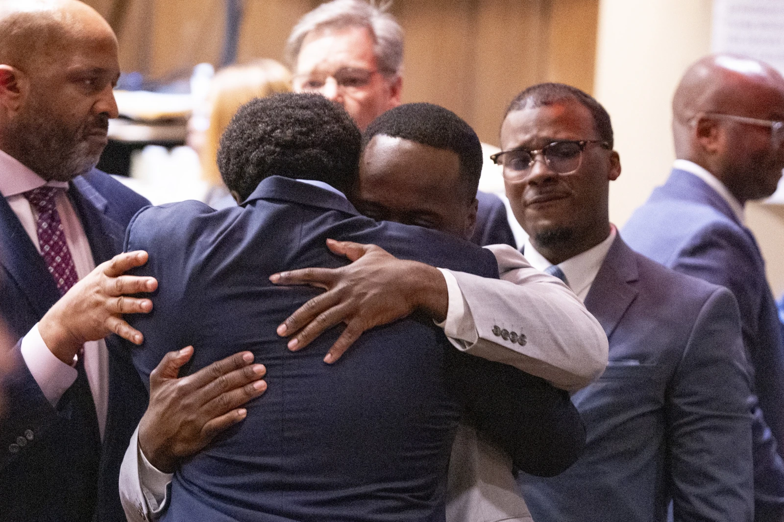 Former Memphis Police Department officers Demetrius Haley, left, and Tadarrius Bean, center, hug as Justin Smith Jr., right, becomes emotional behind them after they were acquitted of state charges, including second-degree murder, in the fatal beating of Tyre Nichols after he ran away from a traffic stop. Wednesday, May 7, 2025, in Memphis, Tenn. (Chris Day/Commercial Appeal/USA Today Network via AP, Pool)