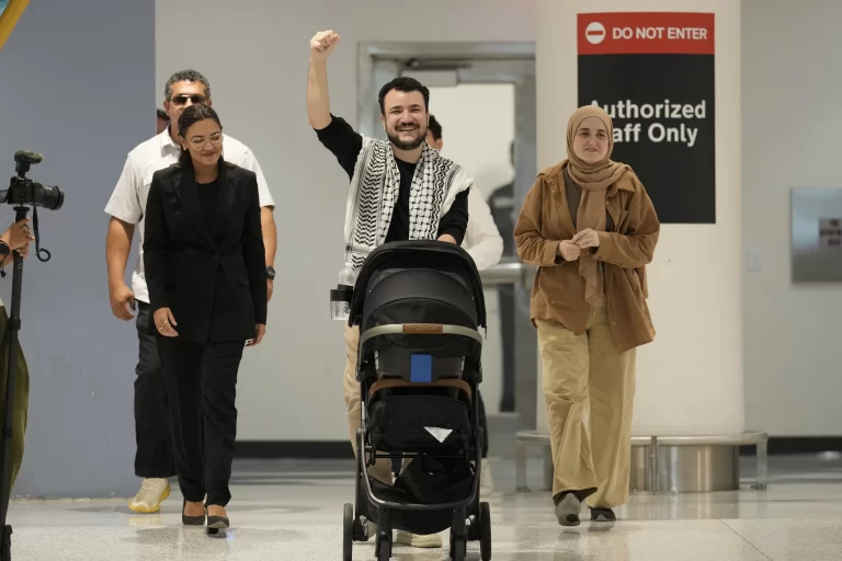 Mahmoud Khalil, center, reacts alongside his wife, Noor Abdalla, right, upon arriving at Newark International Airport , Saturday, June 21, 2025, in Newark, N.J. (AP Photo/Seth Wenig)