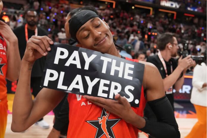 Brittney Sykes holds protest sign after WNBA All-Star Game