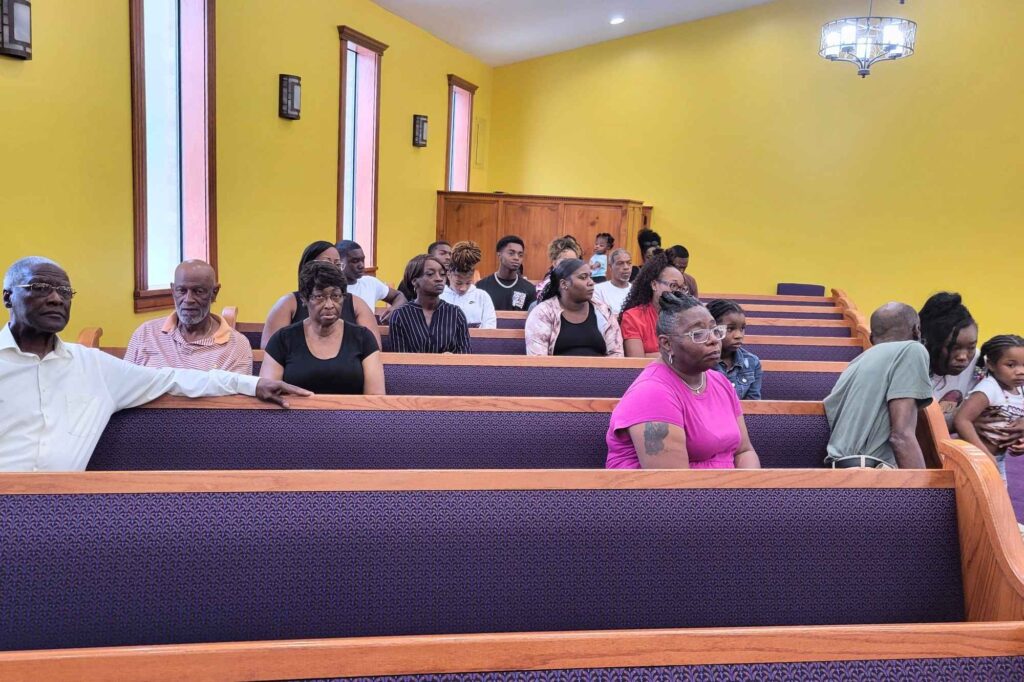 Family members of the late 21-year-old Trey Reed gathered in Living Faith Miracle Temple Church of God in Christ’s pews during the press conference Tuesday, Sept. 16, 2025. Photo by Kevin Edwards, Mississippi Free Press