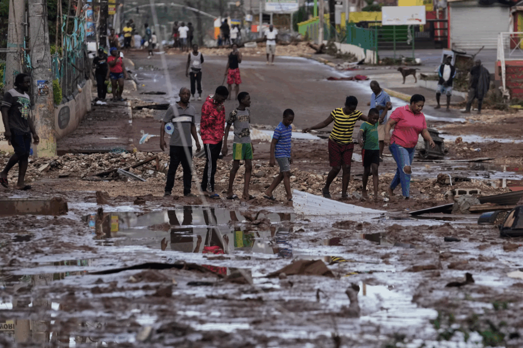 People walk through Santa Cruz, Jamaica, Wednesday, Oct. 29, 2025, after Hurricane Melissa passed. Matias Delacroix/AP