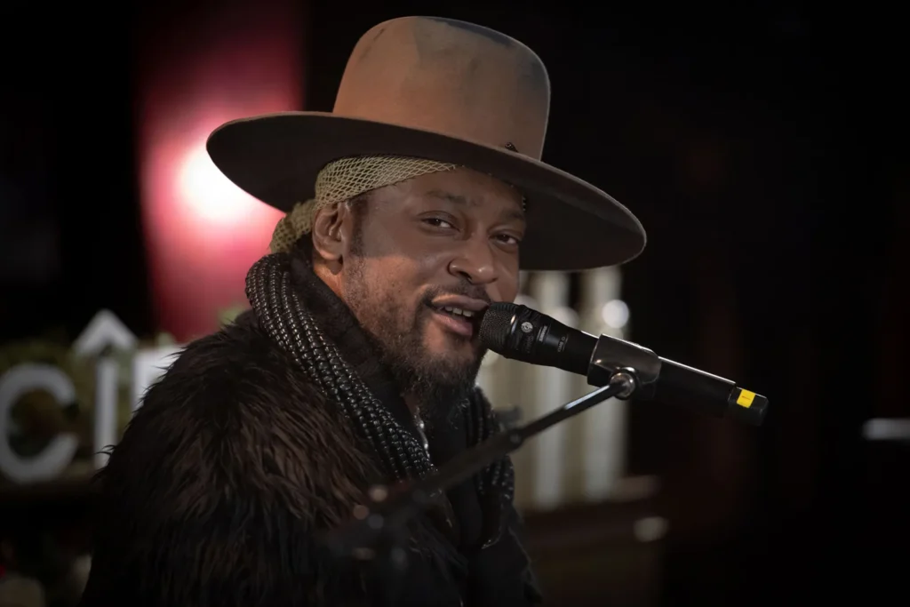 D’Angelo performing live, embodying the spirit of neo-soul and funk.