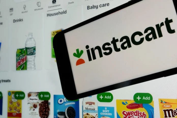 An instacart logo and an instacart webpage are shown in this photo, in New York, on Sept. 6, 2023. (AP Photo/Richard Drew, File)