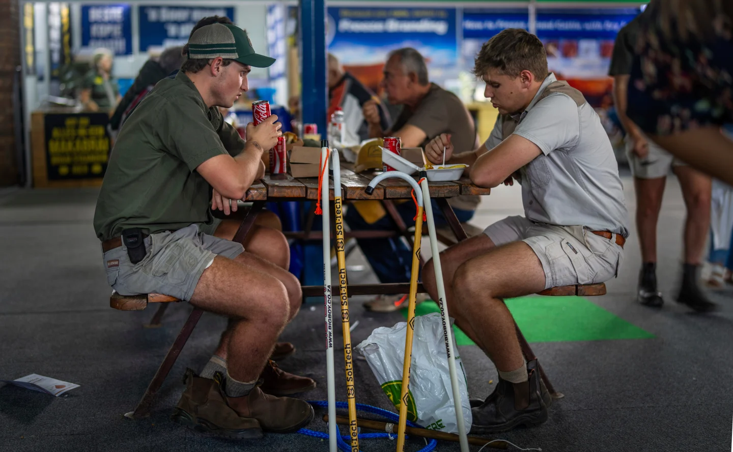 Farmers sit for lunch at the Nampo agricultural fair, one of the largest in the southern hemisphere, near Bothaville, South Africa, May 15, 2025. Credit: AP/Jerome Delay