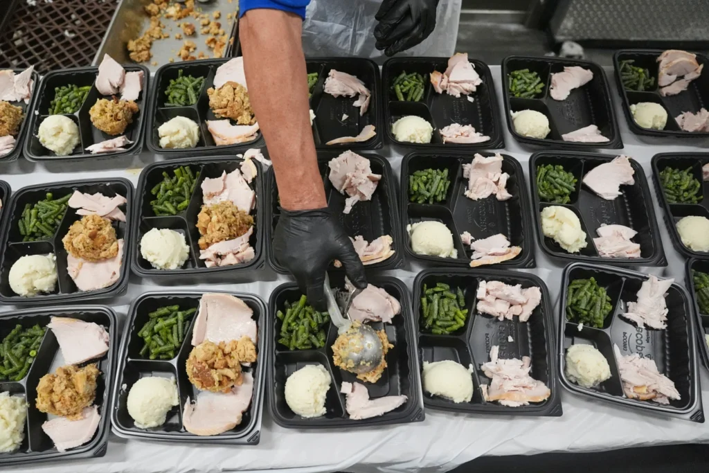 A volunteer prepares meals at the Philabundance Community Kitchen in Philadelphia, Thursday, Oct. 30, 2025.
Matt Rourke/AP