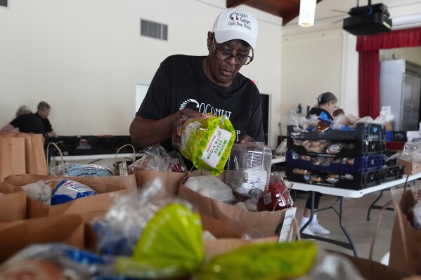 Volunteers prepare food boxes as states scramble to fill the gap ahead of the SNAP benefits halt on November 1 amid Trump administration shutdown.