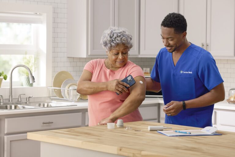 Patient and nurse reviewing continuous glucose monitor together