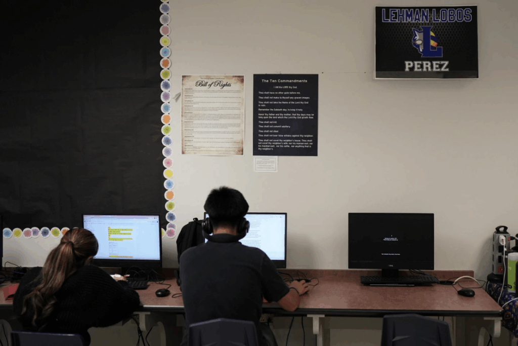 Students work under Ten Commandments and Bill of Rights posters on display in a classroom at Lehman High School, in Kyle, Texas, Thursday, Oct. 16, 2025. (AP Photo/Eric Gay)