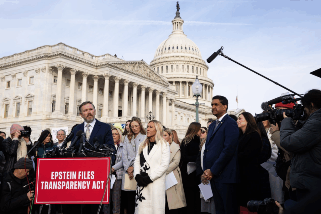 Reps. Thomas Massie (R-Ky.), Marjorie Taylor Greene (R-Ga.), and Ro Khanna (D-Calif.) stand alongside Epstein victims during a news conference Tuesday. | Francis Chung/POLITICO