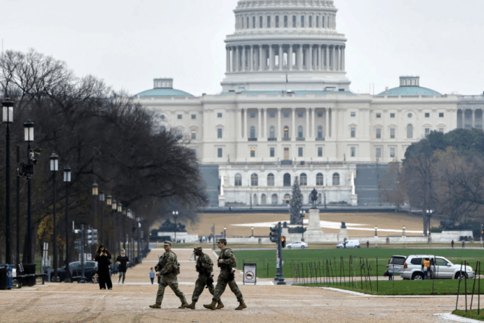 National Guard patrol on the National Mall near the U.S. Capitol, Wednesday, Nov. 26, 2025, in Washington. (AP Photo/Rahmat Gul)