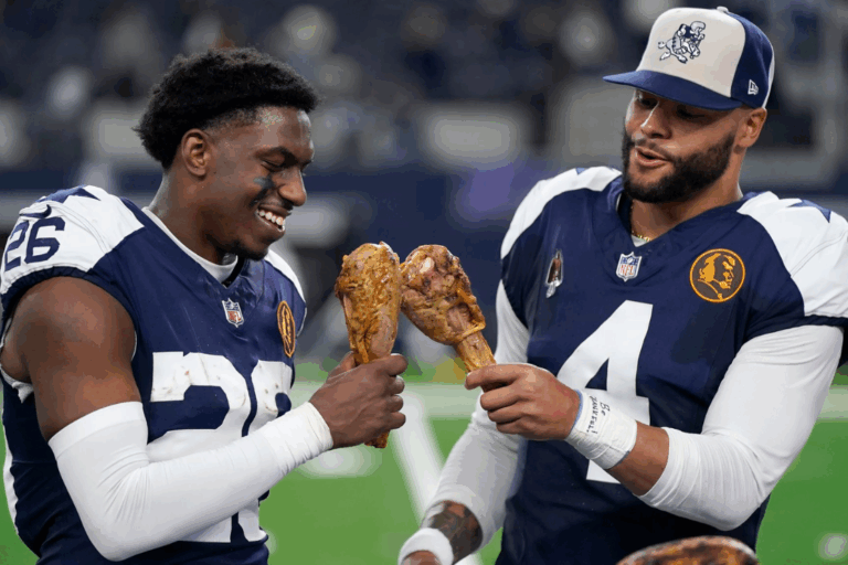Dallas Cowboys cornerback DaRon Bland, left, and quarterback Dak Prescott celebrate by eating Thanksgiving turkey legs after the Cowboys defeated the Washington Commanders during the 2023 season