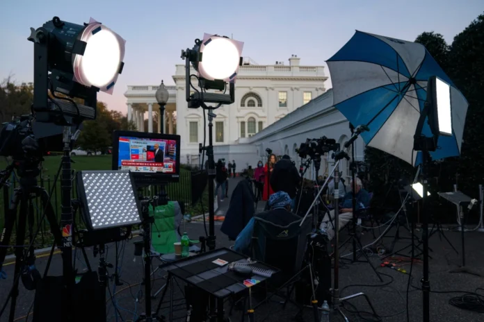 A feed from the MSNBC cable news channel is pictured on a monitor as media organizations set up outside the White House, Nov. 6, 2020, in Washington. (AP Photo/Evan Vucci, File)