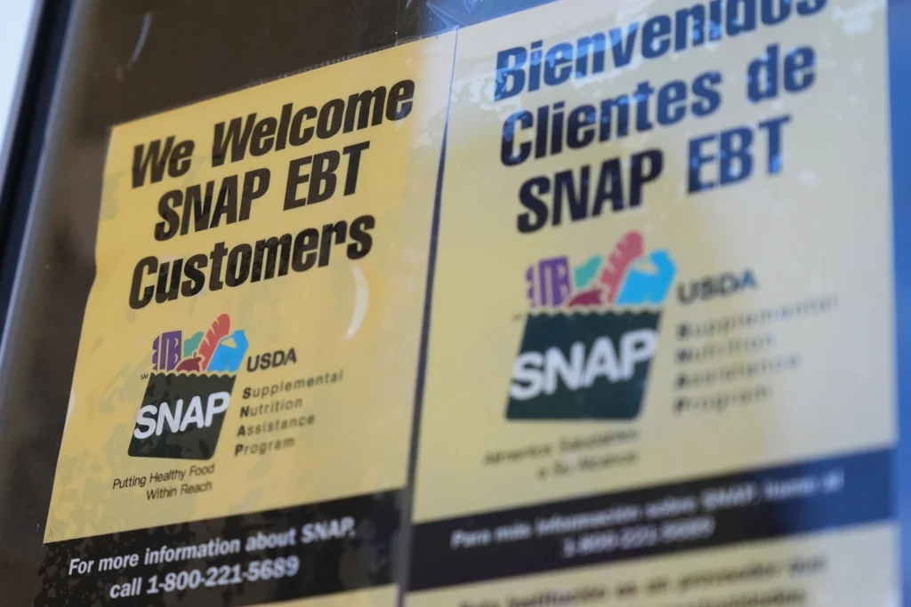 A SNAP EBT information sign is displayed outside of a convenience store in Baltimore, Monday, Nov. 10, 2025. (AP
Photo/Stephanie Scarbrough)
