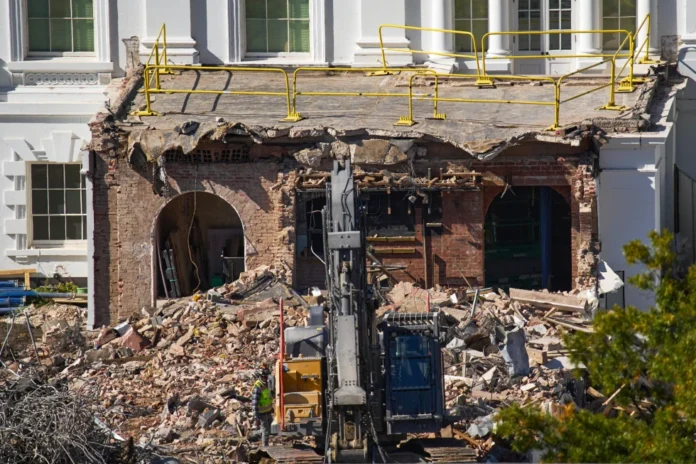 A worker walks among debris from a largely demolished part of the East Wing of the White House, Oct. 23, 2025, in Washington, before construction of a new ballroom. (AP Photo/Jacquelyn Martin)