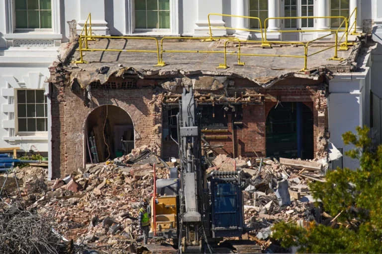 A worker walks among debris from a largely demolished part of the East Wing of the White House, Oct. 23, 2025, in Washington, before construction of a new ballroom. (AP Photo/Jacquelyn Martin)