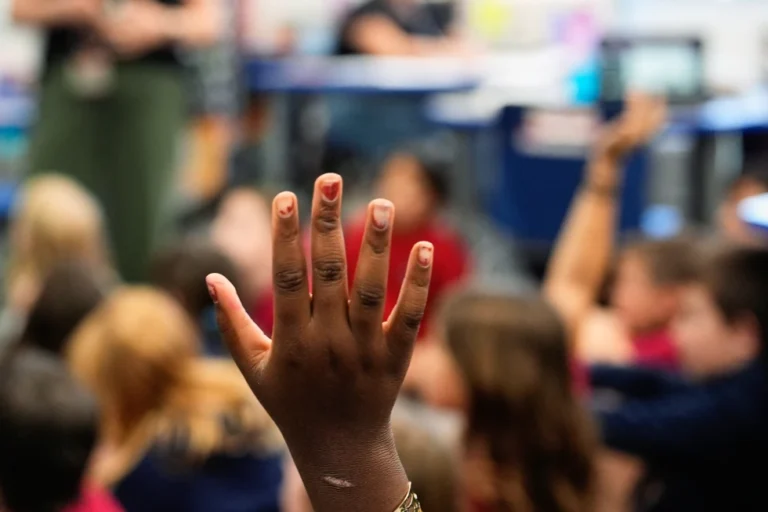 A student raises her hand at A.D. Henderson School in Boca Raton, Fla., April 16, 2024. (AP Photo/Rebecca Blackwell, File)