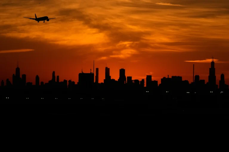 An airplane descends to land at O'Hare International Airport in Chicago, Wednesday, Nov. 12, 2025. (AP Photo/Nam Y. Huh)