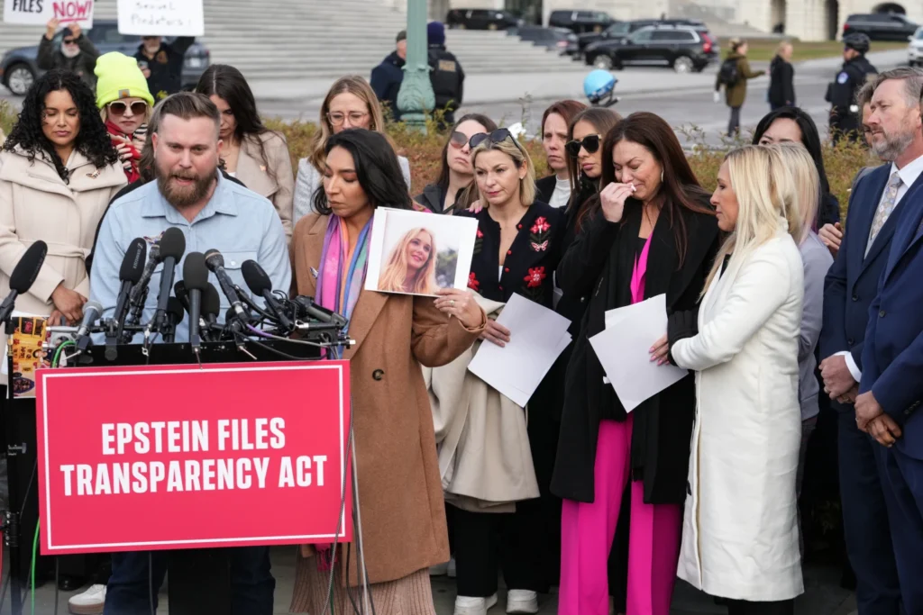 Sky Roberts, brother of prominent Epstein accuser Virginia Giuffre, speaks as his wife Amanda holds her photograph during a news conference as the House prepares to vote on the Epstein Files Transparency Act, at the Capitol in Washington, Tuesday, Nov. 18, 2025. Rep. Marjorie Taylor-Greene, R-Ga., and Rep. Thomas Massie, R-Ky., listen at right. (AP Photo/J. Scott Applewhite) In this July 30, 2008, file photo, Jeffrey Epstein, center, appears in court in West Palm Beach, Fla. (Uma Sanghvi/The Palm Beach Post via AP, File) 6 of 6 | In this July 30, 2008, file photo, Jeffrey Epstein, center, appears in court in West Palm Beach, Fla. (Uma Sanghvi/The Palm Beach Post via AP, File)