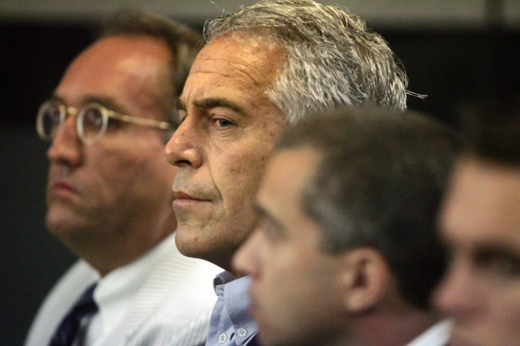 In this July 30, 2008, file photo, Jeffrey Epstein, center, appears in court in West Palm Beach, Fla. (Uma Sanghvi/The Palm Beach Post via AP, File)