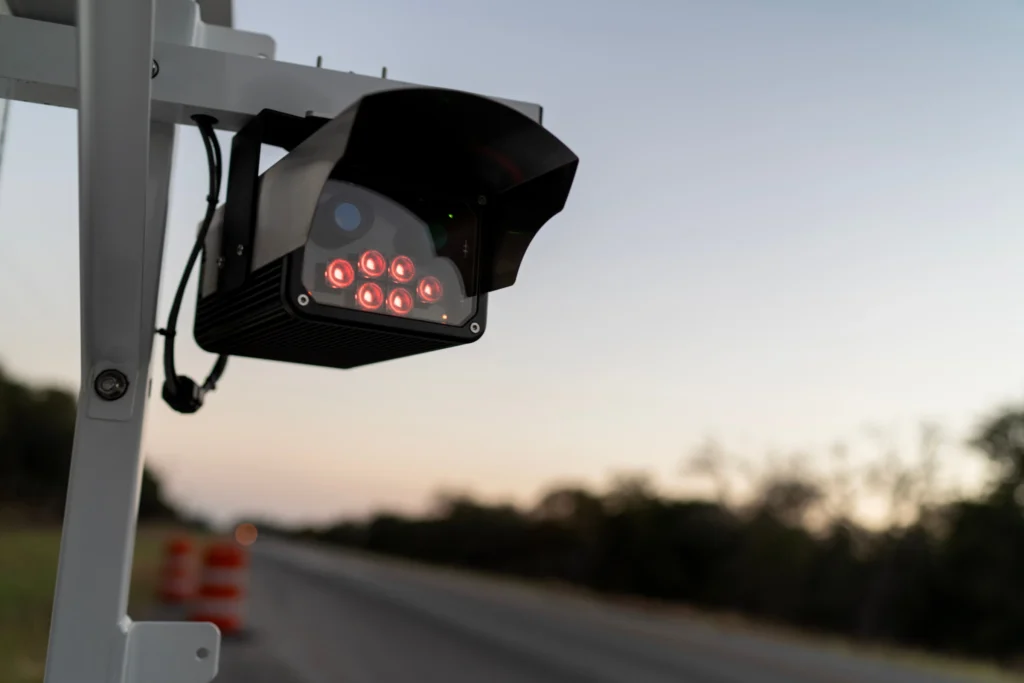 A license plate reader stands along the side of a road, Wednesday, Oct. 15, 2025, in Stockdale, Texas. (AP Photo/David Goldman)