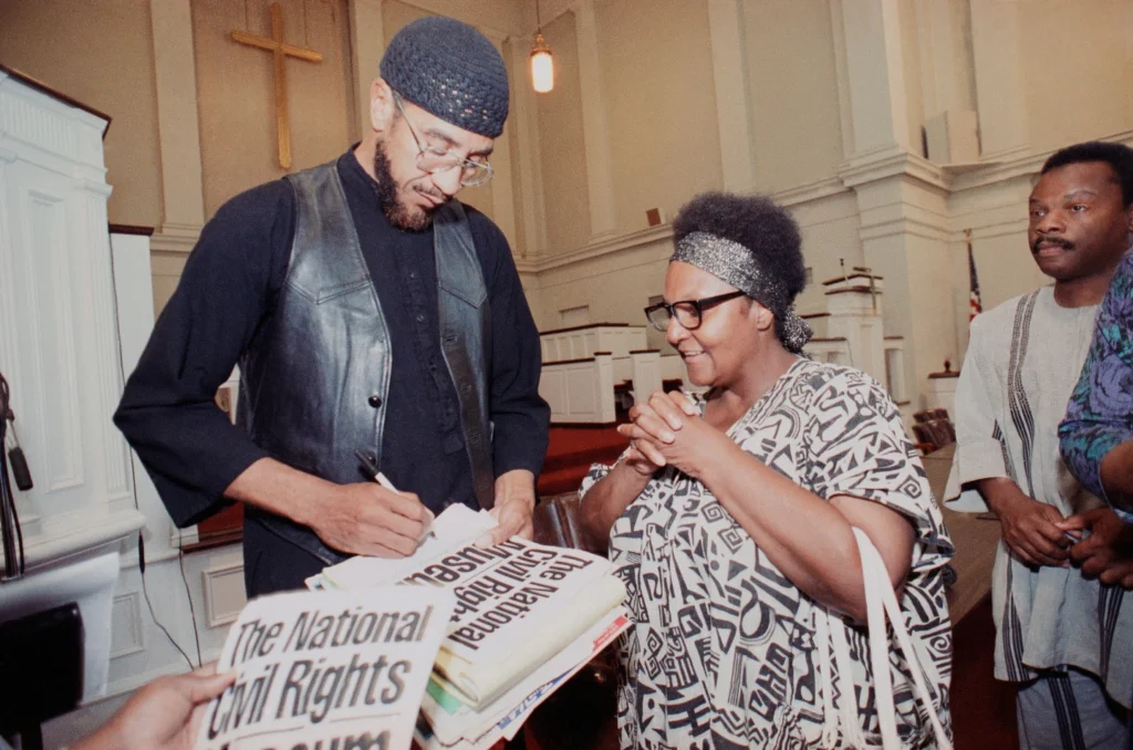 Jamil Al-Amin, formerly known as H. Rap Brown, signs a program after speaking on Monday, July 1, 1991 in Memphis. (AP Photo/Mark Humphrey, File)