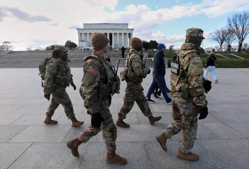 National Guard patrol the National Mall near the Lincoln Memorial, Friday, Nov. 28, 2025, in Washington. (AP Photo/Rahmat Gul)
