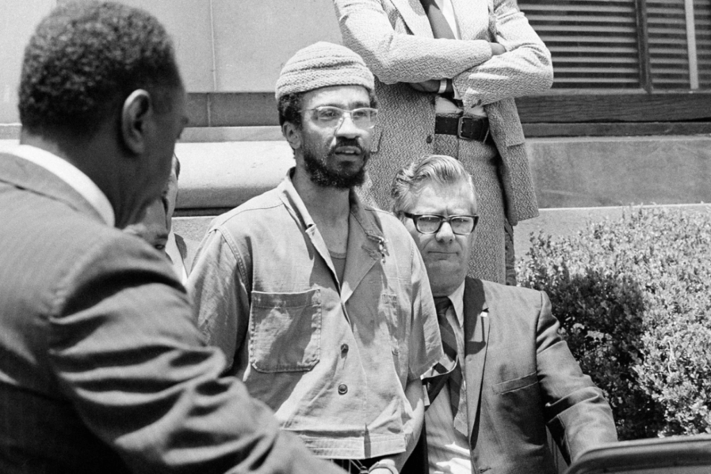 H. Rap Brown is escorted to a car by federal officers in New Orleans, June 2, 1972, after he was sentenced to five years in prison on a federal gun control conviction. Brown is also facing charges in New York in connection with a tavern holdup. (AP Photo/Jack Thornell, File)