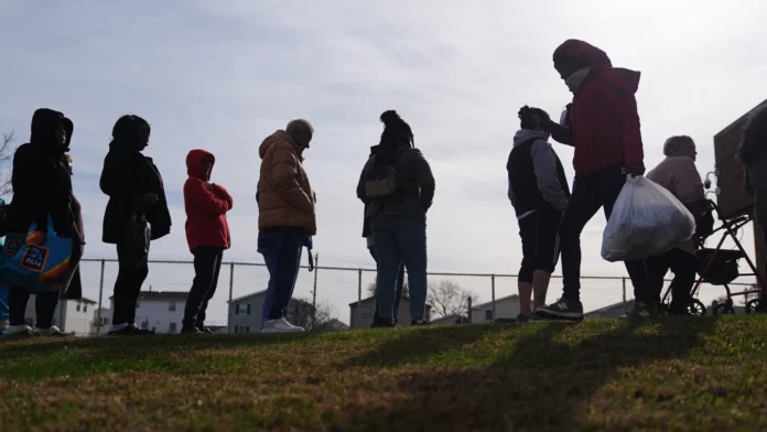 People wait in line durning an emergency food distribution at The Jewish Federation of Greater Philadelphia's Mitzvah Food Program in Philadelphia, Friday, Nov. 7, 2025. (AP Photo/Matt Rourke)