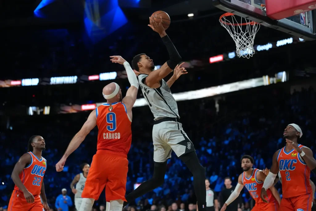 San Antonio Spurs forward Victor Wembanyama (1) goes to the basket as Oklahoma City Thunder guard Alex Caruso (9) defends during the fourth quarter at T-Mobile Arena. Kirby Lee-Imagn Images