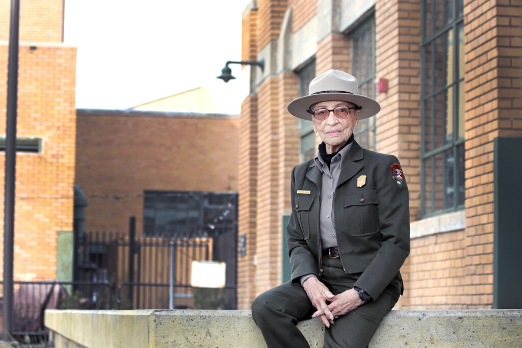 Ranger Betty Reid Soskin sits in front of the Rosie the Riveter/WWII Home Front National Historical Park Visitor Education Center. NPS Photo, Luther Bailey