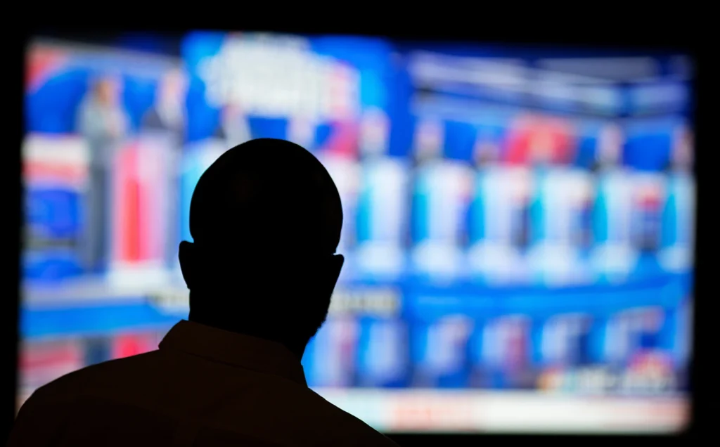 Offei Koram watches a broadcast of a Democratic presidential debate at a bar in Atlanta, June 27, 2019. (AP Photo/David Goldman, File)
