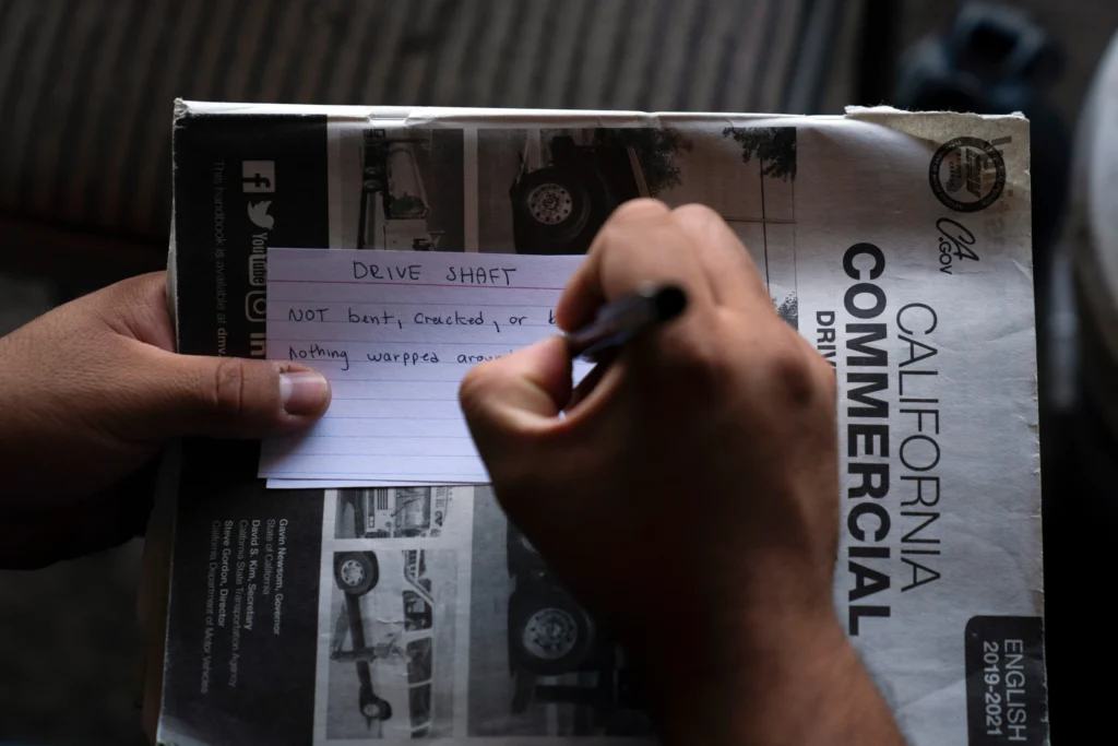 A student truck driver makes flash cards for his commercial driver's license exam while taking a class in Calif., Nov. 15, 2021. (AP Photo/Jae C. Hong, File)