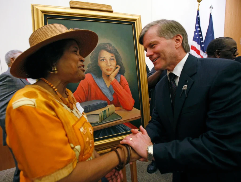 Joan Cobbs, left, sister of civil rights legend Barbara Johns, shakes hands with Virginia Gov. Bob McDonnell, right, after a portrait of Barbara Johns, center, was unveiled in the Virginia State Capitol in Richmond, Va., Sept. 17, 2010. (Bob Brown/Richmond Times-Dispatch via AP)