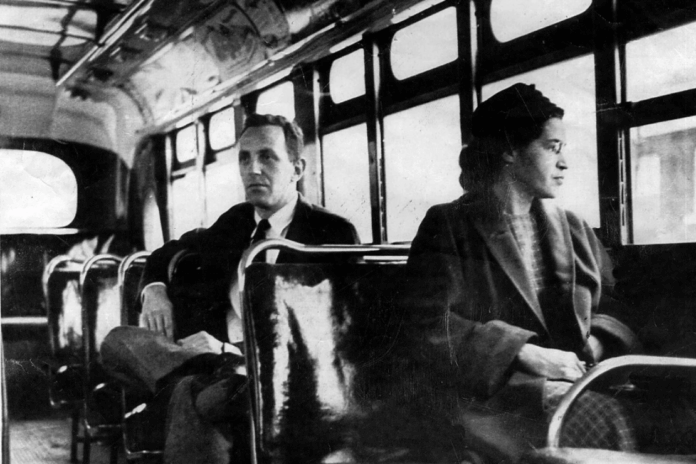 This an undated photo shows Rosa Parks riding on the Montgomery Area Transit System bus. Parks refused to give up her seat on a Montgomery bus on Dec. 1, 1955, and ignited the boycott that led to a federal court ruling against segregation in public transportation. (AP Photo/Daily Advertiser)