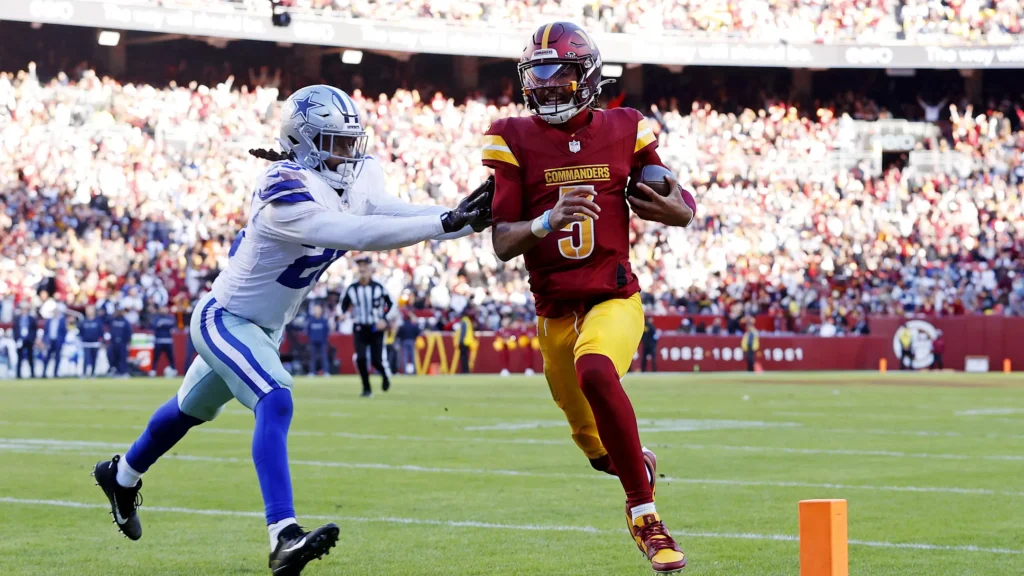  Washington Commanders quarterback Jayden Daniels (5) runs for a touchdown against Dallas Cowboys safety Malik Hooker (28) during the third quarter at Northwest Stadium. Mandatory Credit: Peter Casey-Imagn Images | Peter Casey-Imagn Images