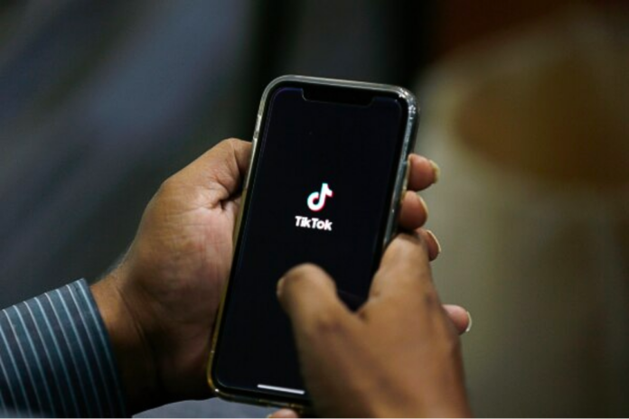 In this July 21, 2020 file photo, a man opens social media app 'TikTok' on his cell phone, in Islamabad, Pakistan. (AP Photo/Anjum Naveed, File)
