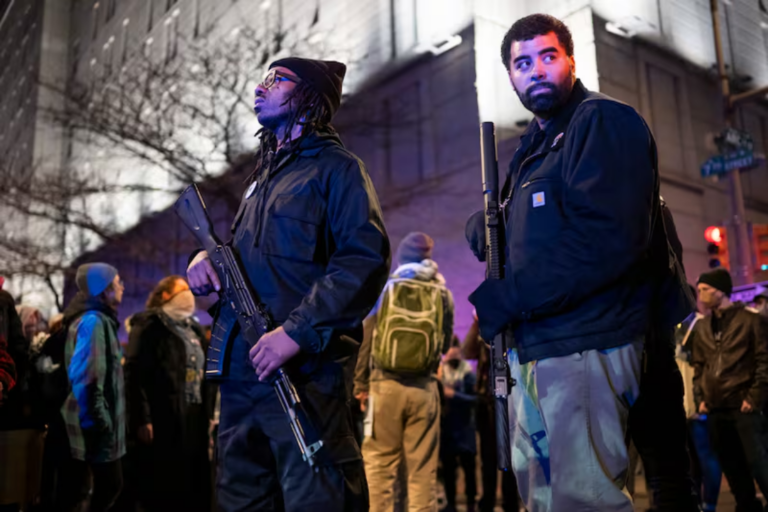 Armed members of the Black Panther Party for Self-Defense, including Paul Birdsong (right), stand among the crowd of protesters as they march throughout Center City on Thursday, Jan. 8, 2026, to rally against the killing of Renee Nicole Good, who was shot by an ICE agent in Minneapolis.Read more Allie Ippolito / For The Inquirer