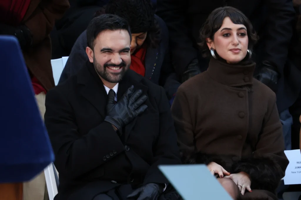 Mayor Zohran Mamdani reacts after arriving for his swearing-in ceremony as Rama Duwaji looks on, Thursday, Jan. 1, 2026, in New York. (AP Photo/Heather Khalifa)