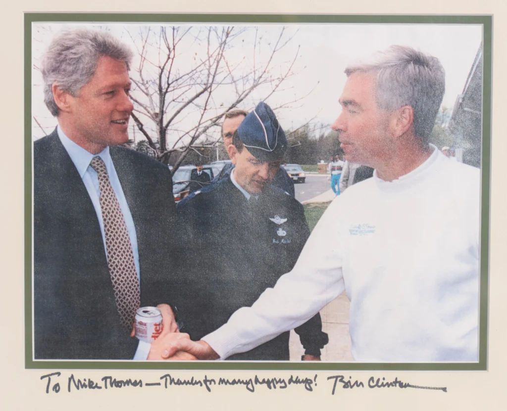 An inscribed photo of President Bill Clinton with Michael Thomas, the former manager of the Courses at Andrews at Joint Base Andrews, is seen Friday, Dec. 19, 2025, in Lothian, Md. (Michael Thomas via AP)